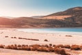 zoom view of the white sandy beach with grass bushes on the famous lake Salda in Turkey. Wonders of nature and turkish