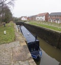 Narrowboat in a lock on a British canal in rural setting Royalty Free Stock Photo