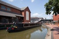 A narrowboat passes through Banbury Canal in North Oxfordshire at the Castle Quay Shopping Centre in the UK