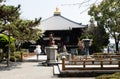 White-clad pilgrim on the grounds of Ryozenji, temple number 1 of Shikoku-henro pilgrimage Royalty Free Stock Photo