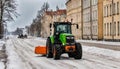 Narva Estonia 10 March 2022 . The tractor cleans road from snow. Spring cleaning of the city