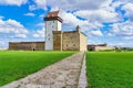 Narva medieval castle with its stone walls and its access road in the green meadow, Royalty Free Stock Photo