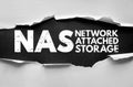 NAS Network Attached Storage phrase in bold cracked text on torn paper background. Represents dedicated data storage devices that Royalty Free Stock Photo