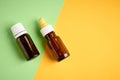 Nasal drops bottle composition, glass bottle on yellow and green background