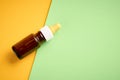 Nasal drops bottle composition, glass bottle on yellow and green background