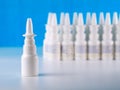 Nasal spray bottle in front of other bottles row Royalty Free Stock Photo