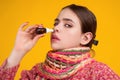 The nasal spray. Female in scarf using nasal spray medicine for runny nose. Nasal spray for allergic rhinitis, cold Royalty Free Stock Photo