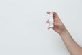 Nasal spray in hands on white background. Royalty Free Stock Photo