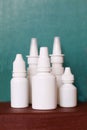 Nasal spray nose drops white vials on a green background Royalty Free Stock Photo