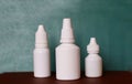 Nasal spray nose drops white vials on a green background Royalty Free Stock Photo