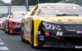 Nascar cars queue race pit lane exit