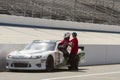 Nascar driver entering car on pit row