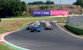 Nascar racing cars group aligned during race formation lap behind safety car motorsport action