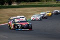 Nascar racing cars group challenging on race track