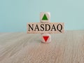 NASDAQ price symbol. A brick block with arrow symbolizing that composite index price are going down or up