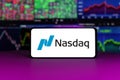 nasdaq stock market index in front of stock market charts background