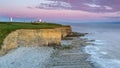 Nash Point Lighthouse, South Wales, At Sunset. The Lighthouse Sits On The Top Of Steep Cliffs