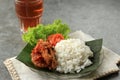 Nasi Ayam Penyet, Indonesian Spicy Chicken with Various Fresh Vegetable