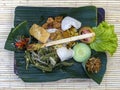 Nasi Campur Bali . Balinese dish of steamed rice with variety of side dishes. Close up. Asian food, Ubud, Bali, Indonesia. Royalty Free Stock Photo