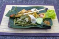 Nasi Campur Bali . Balinese dish of steamed rice with variety of side dishes. Close up. Asian food, Ubud, Bali, Indonesia. Royalty Free Stock Photo