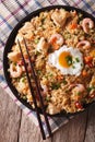 Nasi goreng with chicken, shrimp and vegetables closeup vertica