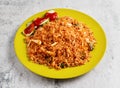 nasi goreng with cucumber served in dish isolated on grey background side view of singapore food