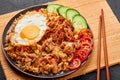 Nasi Goreng - Indonesian Chicken Fried Rice on black plate. Indonesian cuisine dish. Balinese Food. Asian meal