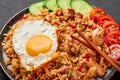 Nasi Goreng - Indonesian Chicken Fried Rice on black plate. Indonesian cuisine dish. Balinese Food. Asian meal