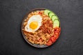 Nasi Goreng - Indonesian Chicken Fried Rice on black plate. Indonesian cuisine dish. Balinese Food. Asian meal