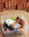 Nasi Kotak or Rice Box or Lunch Box, Popular as Sego Berkat with Chicken, Potato, Egg, Vegetables, and Sambal Royalty Free Stock Photo