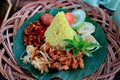 Nasi Kuning. Javanese turmeric rice with assorted side dishes Royalty Free Stock Photo