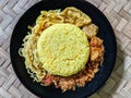 Nasi kuning or turmeric rice, yellow rice or nasi kunyit, top view shot