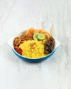 Nasi Kuning Yellow Rice, Indonesian Traditional Steamed Rice with Turmeric, Coconut Milk, and Other Spice. Usually Served for Royalty Free Stock Photo