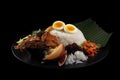 Nasi lemak, malay fragrant rice dish cooked in coconut milk and pandan leaf served with various sid.