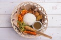 Nasi lemak / Nasi campur, Indonesian Balinese rice with potato fritter, sate lilit, fried tofu, spicy boiled eggs, and peanut