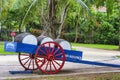 Blue wagon with red wooden wheels and rum barrels Royalty Free Stock Photo