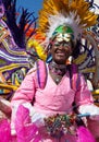 NASSAU, THE BAHAMAS - JANUARY 1 - CU of Female dancer dressed in bright orange feathers and red hearts, dances in Junkanoo