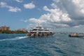 Nassau, Bahamas - May 14, 2019: Luxurious yacht Loon sailing in Nassau harbour.Turquoise water in the foreground. Atlantis resort