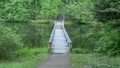 Foot bridge over the lake and stairway in the forest Royalty Free Stock Photo