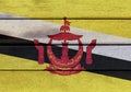 Nation of Brunei flag on wooden surface