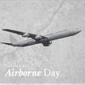 National airborne day text banner and grunge overlay over airplane against grey background