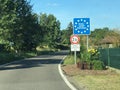 National border roadsign entering Federal Republic of Germany, with stars on blue as symbols for European Union member Royalty Free Stock Photo
