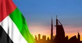 National day of United Arab Emirates. Silhouette of Dubai skyline on background of sunset with UAE flag Royalty Free Stock Photo