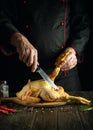 National dish of fried chicken by the hands of the chef in the kitchen of the restaurant. Before cooking, the rooster must be