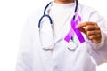 Woman doctor white uniform hold purple ribbon on hand