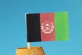 A national flag of Afghanistan on wooden stick in wooden barrel