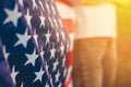 National flag of America close up, selective focus, standing in a field at sunset. 4th of July, Independence day. American freedom Royalty Free Stock Photo