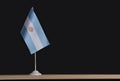 National flag of Argentina on table on black background. Flag pole Royalty Free Stock Photo