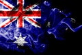 National flag of Australia made from colored smoke isolated on black background. Abstract silky wave background