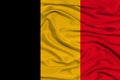 National flag of belgium on gentle silk with wind folds, travel concept, immigration, politics, copy space, close-up